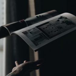 Print magazine open and floating in the air above a hand